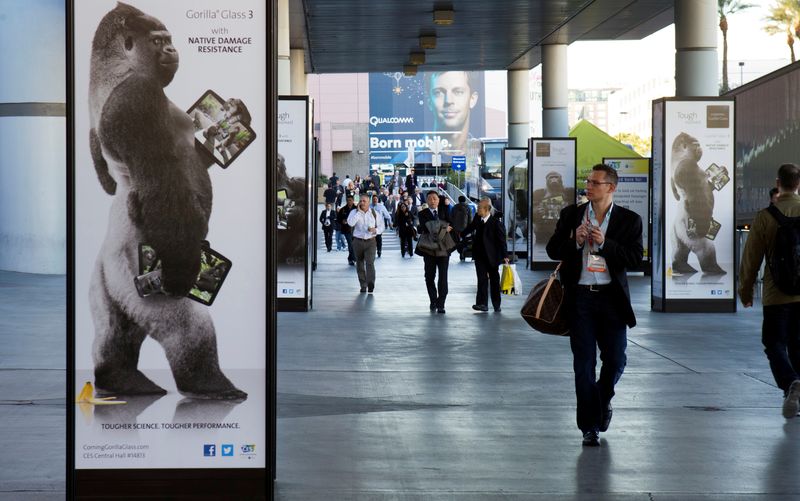 &copy; Reuters. FILE PHOTO: A man walks by an advertisement for Corning Gorilla Glass 3 outside the Las Vegas Convention Center on the first day of the Consumer Electronics Show (CES) in Las Vegas January 8, 2013. REUTERS/Steve Marcus/File Photo        