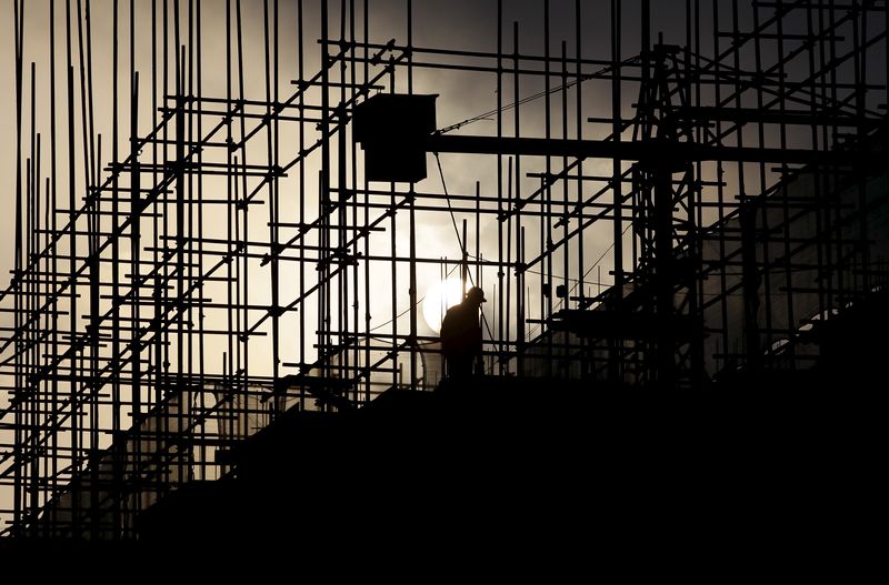 &copy; Reuters. FILE PHOTO: A labourer works during sunrise at a construction site of a residential complex in Puer, Yunnan province, April 23, 2015. REUTERS/Wong Campion/ File Photo