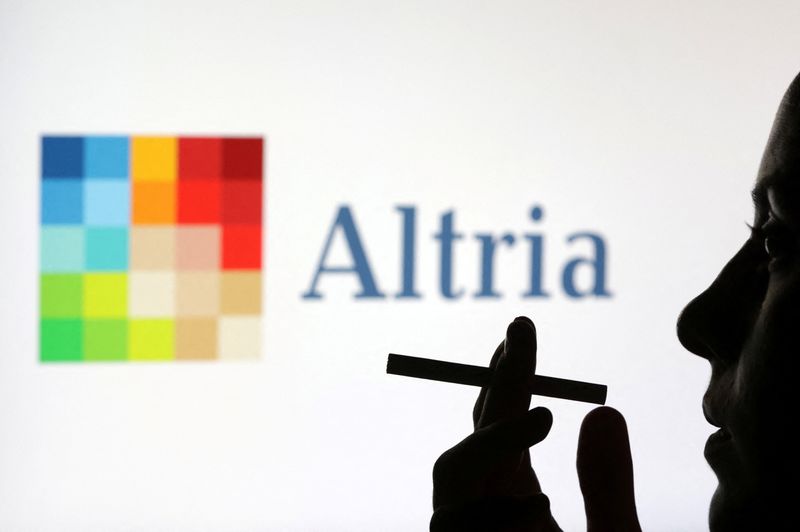 © Reuters. FILE PHOTO: A woman poses with a cigarette in front of Altria logo in this illustration taken July 26, 2022. REUTERS/Dado Ruvic/Illustration/File Photo