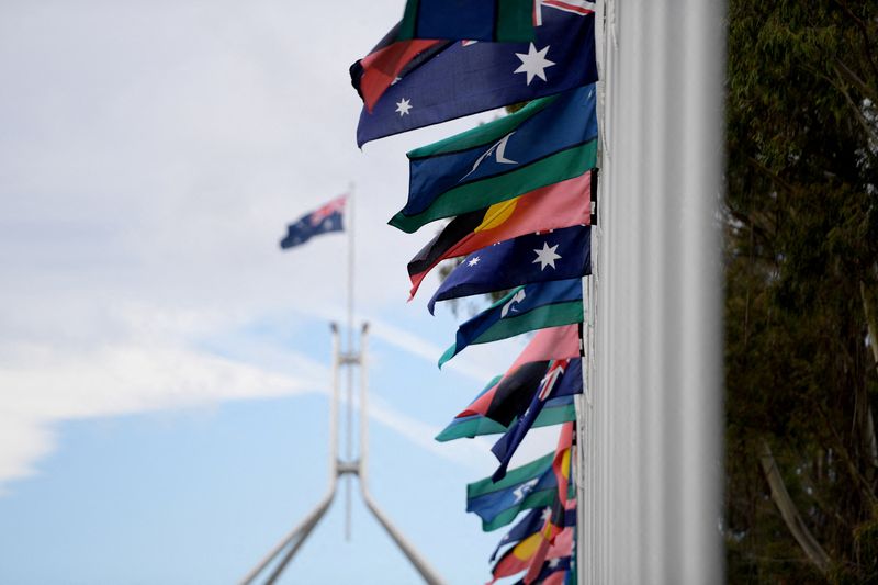 © Reuters. FILE PHOTO: Australian Aboriginal and Torres Strait Islander flags are pictured in front of Parliament House during The Voice referendum in Canberra, Australia, Oct. 14, 2023. REUTERS/Tracey Nearmy/File Photo