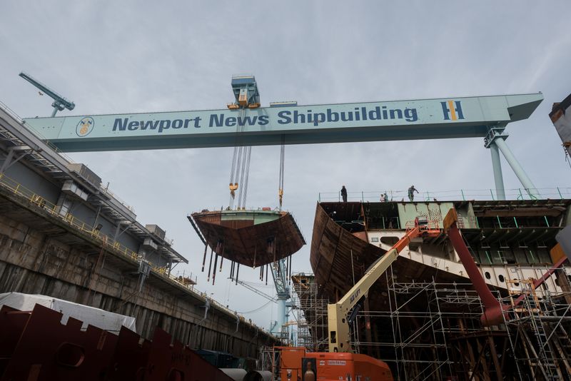 &copy; Reuters. A crane moves the lower stern into place on the nuclear-powered aircraft carrier USS John F. Kennedy (CVN 79) at Huntington Ingalls Shipbuilding in Newport News, Virginia, U.S., in this June 22, 2017 handout photo.  U.S. Navy/Handout via REUTERS/ File Pho