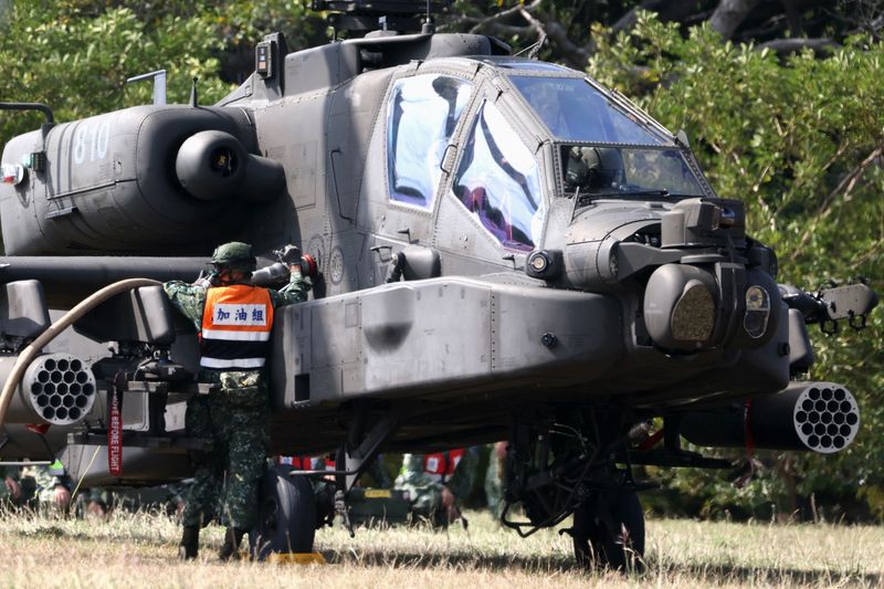 &copy; Reuters. A soldier refuels an AH-64E Apache attack helicopter before take off during 'Combat Readiness Week' drills in Hsinchu, Taiwan, October 29, 2020. REUTERS/Ann Wang/ File Photo