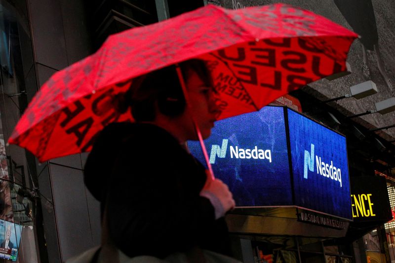 © Reuters. FILE PHOTO: A woman passes by the Nasdaq Market Site in Times Square in New York City, U.S., February 7, 2018. REUTERS/Brendan McDermid/File Photo