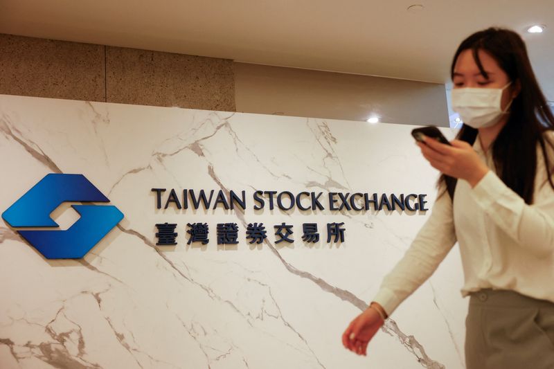 &copy; Reuters. FILE PHOTO: A woman walks past Taiwan Stock Exchange logo outside their office in Taipei, Taiwan August 6, 2024. REUTERS/Carlos Garcia Rawlins/File Photo