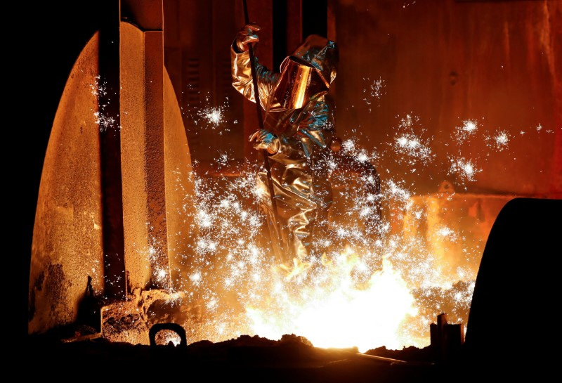 © Reuters. FILE PHOTO: A steel worker of Germany's industrial conglomerate ThyssenKrupp AG takes a sample of raw iron from a blast furnace at Germany's largest steel factory in Duisburg, Germany, January 28, 2019. REUTERS/Wolfgang Rattay/File Photo