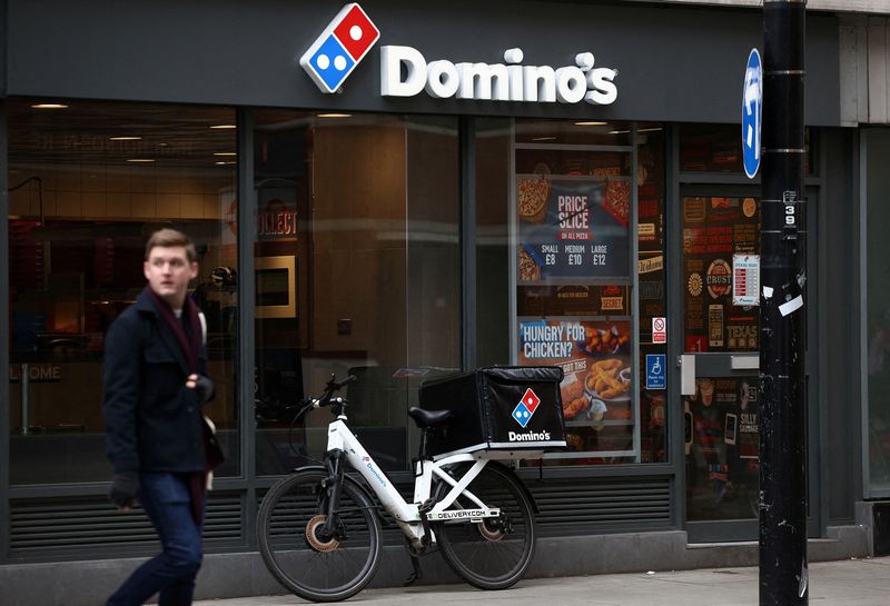 © Reuters. FILE PHOTO: A person walks past a Domino's pizza restuarant in London, Britain, March 4, 2023. REUTERS/Henry Nicholls/File Photo