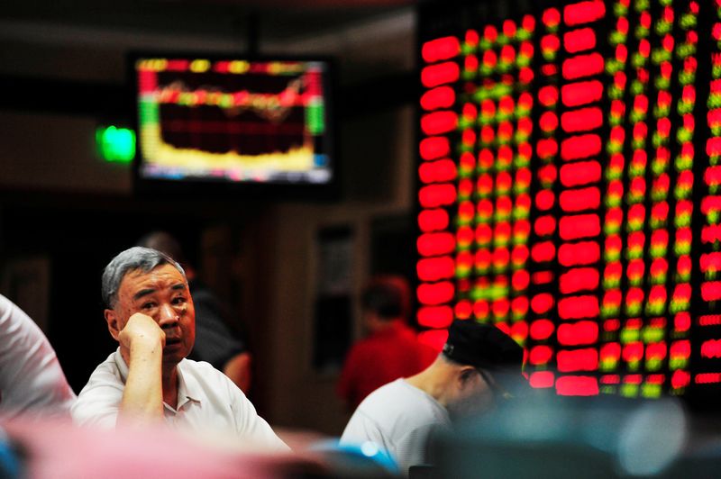 &copy; Reuters. FILE PHOTO: An investor sits in front of an electronic board showing stock information at a brokerage house in Nanjing, Jiangsu province, China, September 27, 2016. REUTERS/Stringer/File Photo