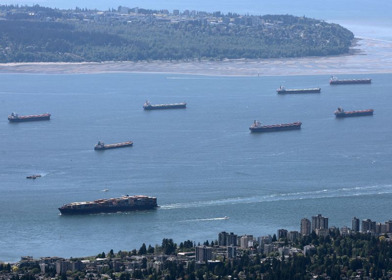 &copy; Reuters. FILE PHOTO: A container ship makes its way into the Port of Vancouver past vessels at anchor in English Bay, as seen from Grouse Mountain in North Vancouver, British Columbia, Canada May 10, 2024. REUTERS/Chris Helgren/File Photo