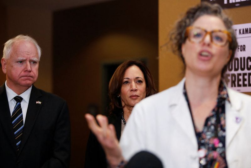 &copy; Reuters. FILE PHOTO: U.S. Vice President Kamala Harris and Minnesota Governor Tim Walz listen to Dr. Sarah Traxler as Harris visits the St. Paul Health Center, a clinic that performs abortions, in St. Paul, Minnesota, U.S., March 14, 2024. REUTERS/Nicole Neri/File