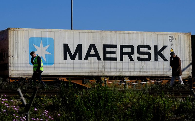 &copy; Reuters. FILE PHOTO: Workers talk on their mobile phones, as a Maersk container is transported by a train, near a port of Barcelona, Spain April 26, 2024. REUTERS/Nacho Doce/File Photo