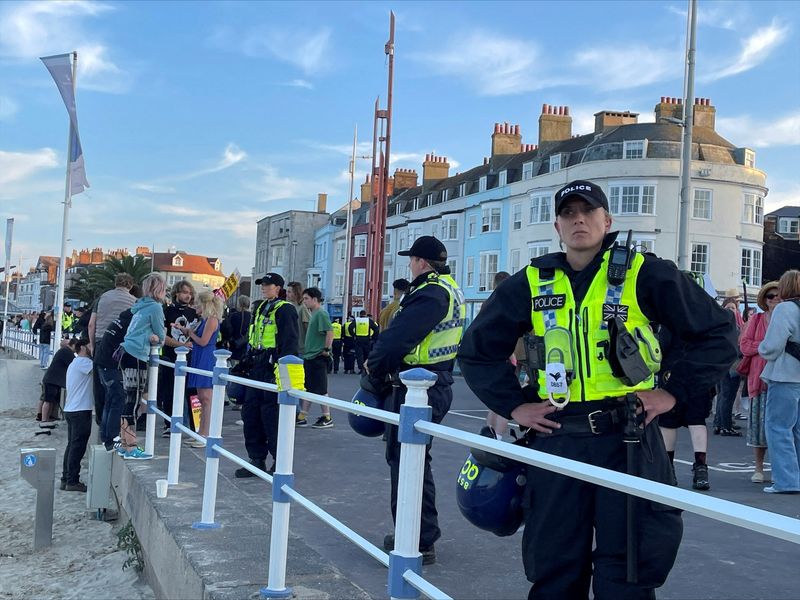 © Reuters. FILE PHOTO: Police wearing riot protection equipment patrol the seafront esplanade following an anti-immigration protest in Weymouth, Britain August 4, 2024. REUTERS/Josephine Mason/File Photo