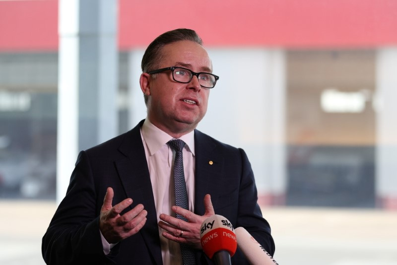 &copy; Reuters. FILE PHOTO: Alan Joyce, Chief Executive Officer of Qantas, speaks with members of the media at an event celebrating Qantas' 100th birthday at Sydney Airport in Sydney, Australia, November 16, 2020.  REUTERS/Loren Elliott/File Photo