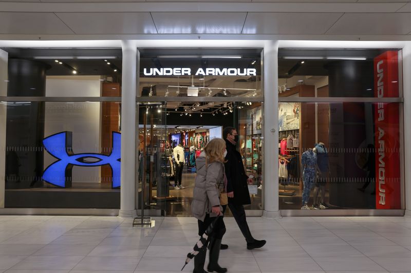 &copy; Reuters. FILE PHOTO: People walk by an Under Armour store in Manhattan, New York City, U.S., February 7, 2022. REUTERS/Andrew Kelly/File Photo