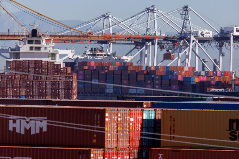 &copy; Reuters. FILE PHOTO: Stacked containers are shown as ships unload their cargo at the Port of Los Angeles in Los Angeles, California, U.S. November 22, 2021. REUTERS/Mike Blake/File Photo