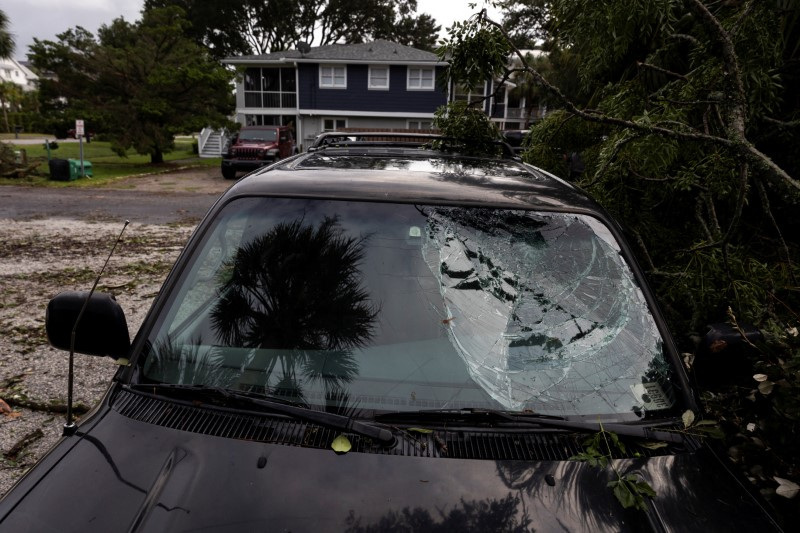 &copy; Reuters. FILE PHOTO: A palm tree is reflected in a car's broken windshield as Tropical Storm Debby moves off Georgia to the North Atlantic, in Isle of Palms, South Carolina, U.S., August 6, 2024. REUTERS/Marco Bello/File Photo