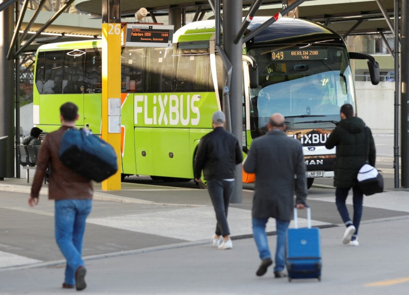 &copy; Reuters. FILE PHOTO: Passengers walk near a Flixbus bus at the main bus station in Berlin, Germany, March 17, 2020.    REUTERS/Fabrizio Bensch/File Photo