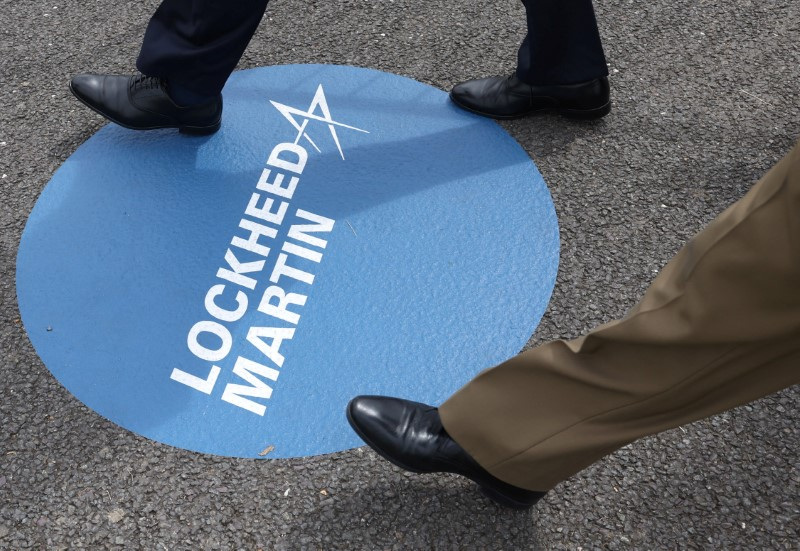 &copy; Reuters. Attendees walk over branding for Lockheed Martin at the Farnborough International Airshow, in Farnborough, Britain, July 22, 2024. REUTERS/Toby Melville/File Photo