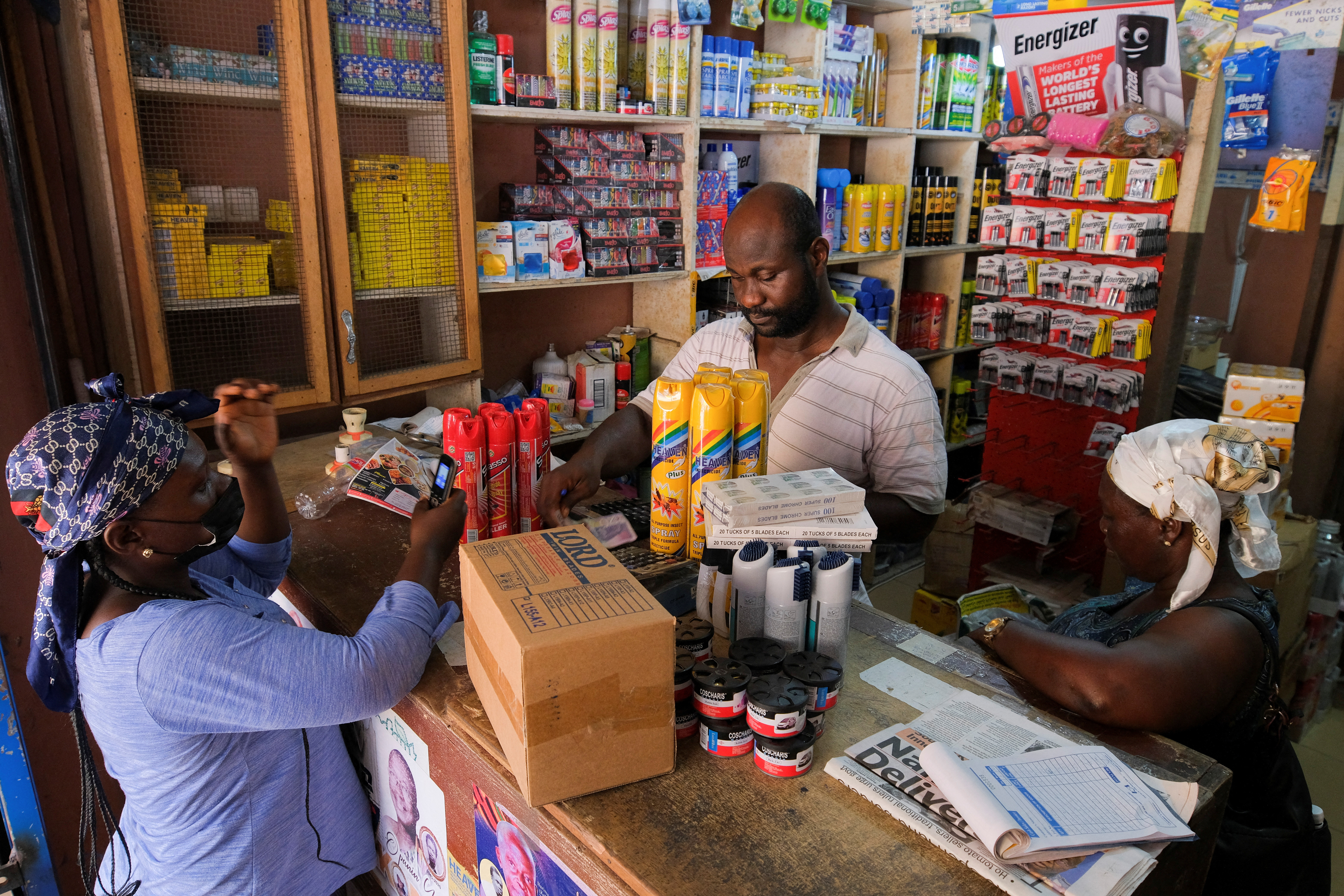 © Reuters. Mr Isaac Siaw, 42, a shop owner, attends customers at Makola market, one of the country's largest trading centres in Accra, Ghana March 26, 2022.  REUTERS/Francis Kokoroko/ File Photo