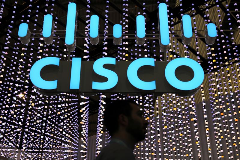 © Reuters. FILE PHOTO: A man passes under a Cisco logo at the Mobile World Congress in Barcelona, Spain February 25, 2019. REUTERS/Sergio Perez/File Photo