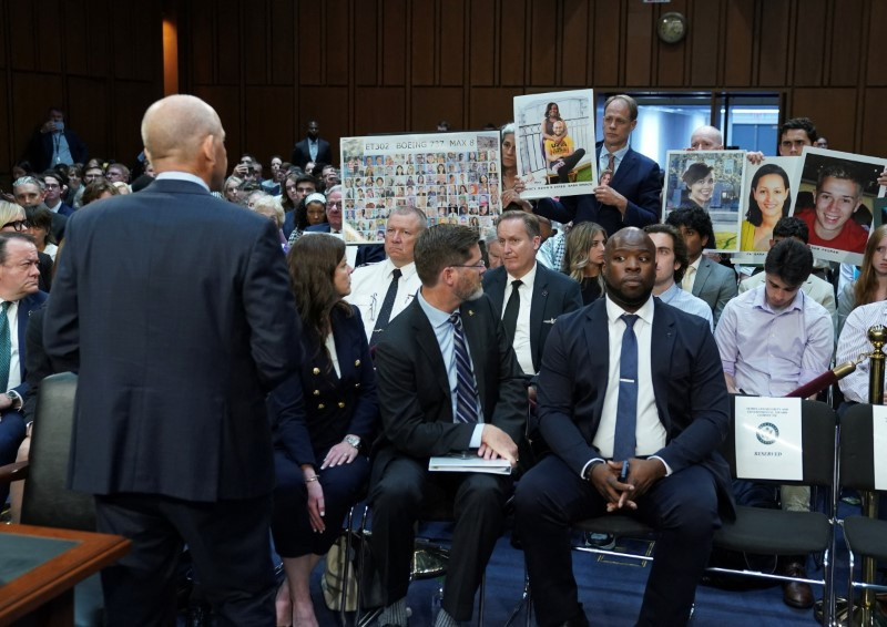 © Reuters. FILE PHOTO: Placard with photos of those killed on Ethiopian Airlines Flight 302 is held up during a Senate Homeland Security and Governmental Affairs Committee Investigations Subcommittee hearing on the safety culture at Boeing, on Capitol Hill in Washington, U.S., June 18, 2024. REUTERS/Kevin Lamarque/File Photo