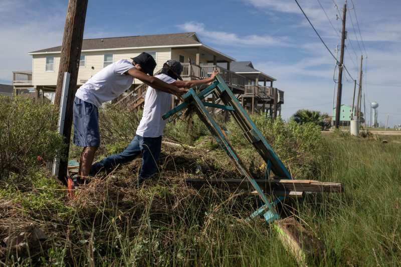 © Reuters. FILE PHOTO: Restaurant employees collect displaced tables in the aftermath of Hurricane Beryl in Surfside Beach, Texas, U.S., July 8, 2024.  REUTERS/Adrees Latif/File Photo