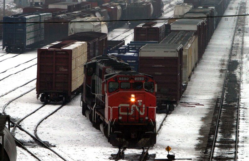 © Reuters. FILE PHOTO: A Canadian National Railway Co. train reverses along one of the tracks at the CN MacMillan Yard in the north end of Toronto, February 20, 2004.  REUTERS/Mike Cassese  MC/File Photo