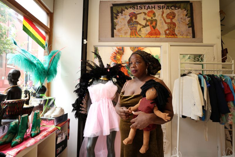 © Reuters. Ngozi Fulani, CEO and founder of Sistah Space, poses for a portrait holding a Survivor Doll at their shop in London, Britain, August 15, 2024. Sistah Space is a London-based charity that focuses on supporting Black British, African and Caribbean victims of domestic violence. REUTERS/Hollie Adams