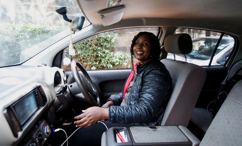 © Reuters. Kenyan taxi driver Judith Chepkwony sits inside her vehicle during a Reuters interview about reduced fares, in Nairobi, Kenya, August 14, 2024. REUTERS/Monicah Mwangi