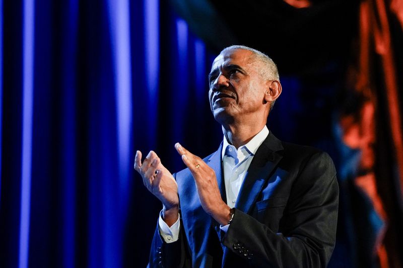 © Reuters. Former U.S. President Barack Obama applauds as he participates in a discussion moderated by Stephen Colbert, host of CBS's 