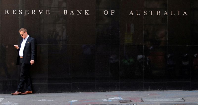 &copy; Reuters. FILE PHOTO: A man smokes next to the Reserve Bank of Australia headquarters in central Sydney, Australia February 6, 2018. REUTERS/Daniel Munoz/File Photo