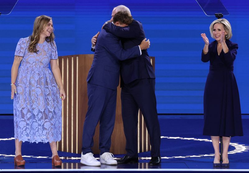 &copy; Reuters. U.S. Democratic vice presidential nominee Minnesota Governor Tim Walz embraces his son Gus as his wife Gwen and his daughter Hope react onstage on Day 3 of the Democratic National Convention (DNC) at the United Center, in Chicago, Illinois, U.S., August 2