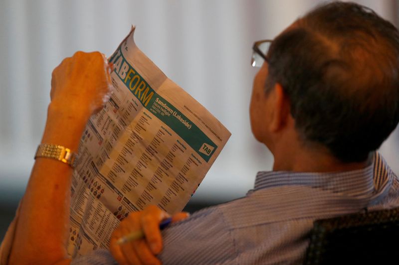 © Reuters. A man reads the TAB betting section of a newspaper at a TAB branch in Sydney, Australia, February 7, 2018. Picture taken February 7, 2018. REUTERS/Daniel Munoz/File photo