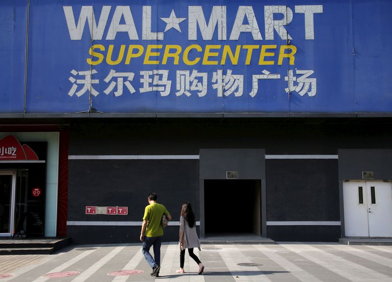 &copy; Reuters. FILE PHOTO: Pedestrians walk past a signboard of Wal-Mart at its branch store in Beijing, China, October 15, 2015.   REUTERS/Kim Kyung-Hoon/File Photo