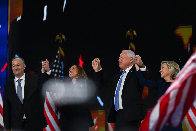 &copy; Reuters. Democratic presidential nominee and U.S. Vice President Kamala Harris, her husband Doug Emhoff, Democratic vice presidential nominee Minnesota Governor Tim Walz, and his wife Gwen stand onstage on Day 4 of the Democratic National Convention (DNC) at the U