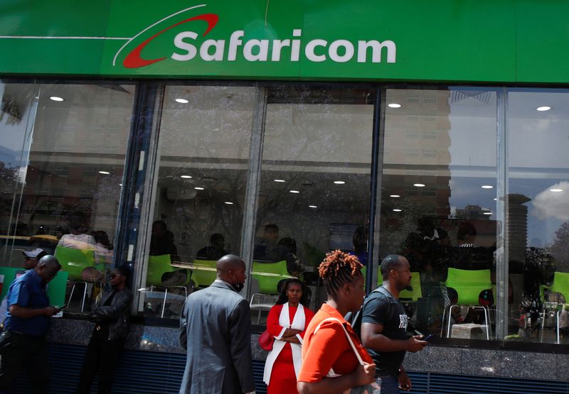 &copy; Reuters. Pedestrians walk outside the Safaricom mobile phone customer care centre during the launch of its 5G internet service in the central business district of Nairobi, Kenya October 27, 2022. REUTERS/Monicah Mwangi/File Photo