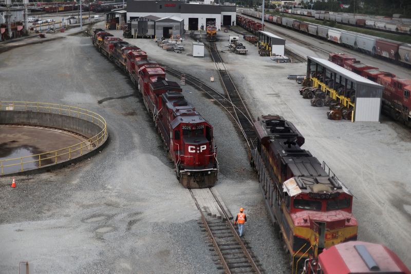 &copy; Reuters. FILE PHOTO: A worker walks at Canadian Pacific Kansas City rail yard, as seen from an overpass, in Port Coquitlam, British Columbia, Canada August 22, 2024. REUTERS/Jesse Winter/File Photo