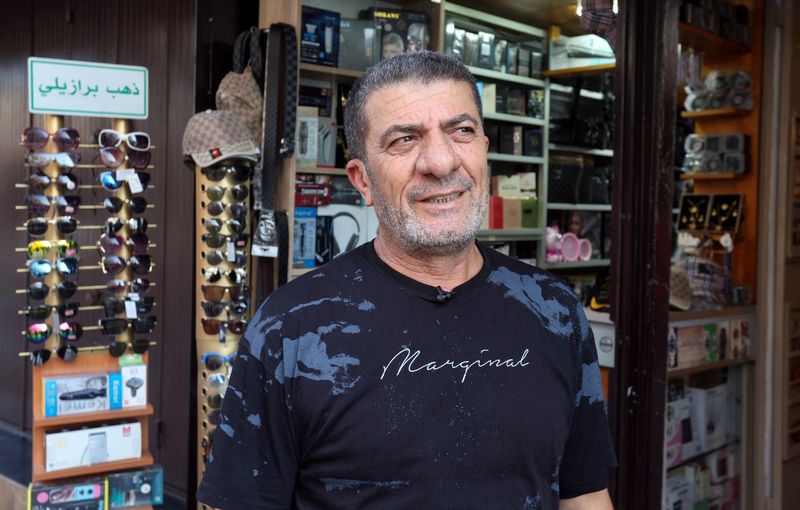 © Reuters. Shop owner Mohamed Ftouni attends an interview with Reuters as he stands outside his shop in Tyre, southern Lebanon August 26, 2024. REUTERS/Aziz Taher