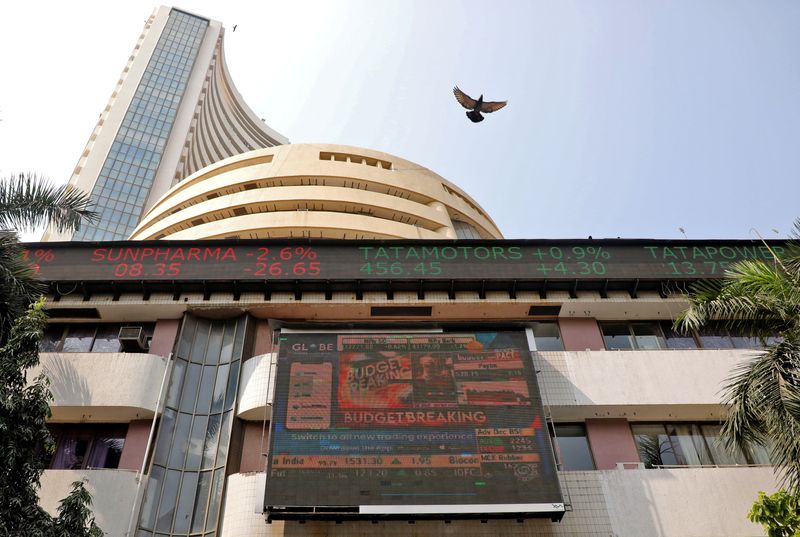 © Reuters. FILE PHOTO: A bird flies past a screen showing Sensex results on the facade of the Bombay Stock Exchange (BSE) building in Mumbai February 1, 2023. REUTERS/Niharika Kulkarni/File Photo