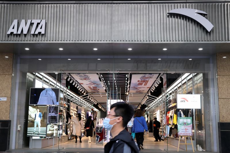 &copy; Reuters. FILE PHOTO: A man walks past a store of Chinese sportswear firm Anta Sports at a shopping mall in Beijing, China March 25, 2021. REUTERS/Florence Lo/File Photo