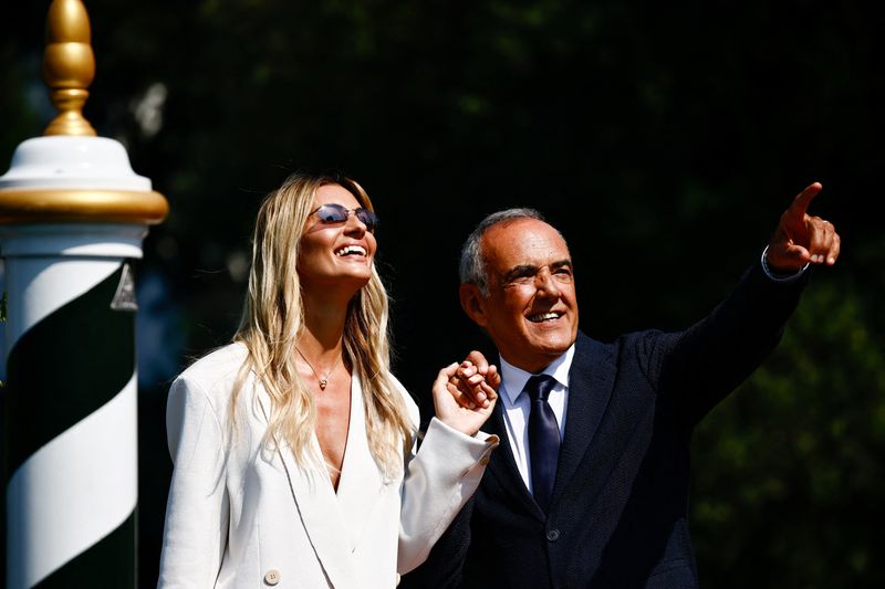 © Reuters. Actor Sveva Alviti, who will host the opening ceremony of the 81st Venice Film Festival, and director Alberto Barbera react, in Venice, Italy, August 27, 2024. REUTERS/Yara Nardi