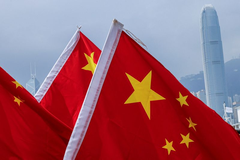 © Reuters. FILE PHOTO: Chinese national flags are seen outside the Central Financial District on China's National Day in Hong Kong, China, October 1, 2023. REUTERS/Tyrone Siu/File Photo