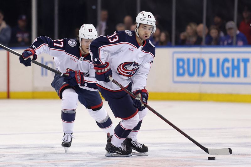 &copy; Reuters. FILE PHOTO: Feb 28, 2024; New York, New York, USA; Columbus Blue Jackets left wing Johnny Gaudreau (13) brings the puck up ice against the New York Rangers with defenseman Adam Boqvist (27) during the first period at Madison Square Garden. Mandatory Credi