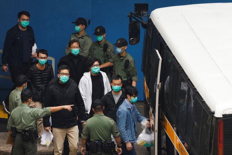 © Reuters. FILE PHOTO: Pro-democracy activists Ventus Lau Wing-hong, Kwok Ka-ki, Lam Cheuk-ting and Raymond Chan Chi-chuen walk to a prison van to head to court with other activists, over a national security law charge, in Hong Kong, China March 4, 2021. REUTERS/Tyrone Siu/File Photo