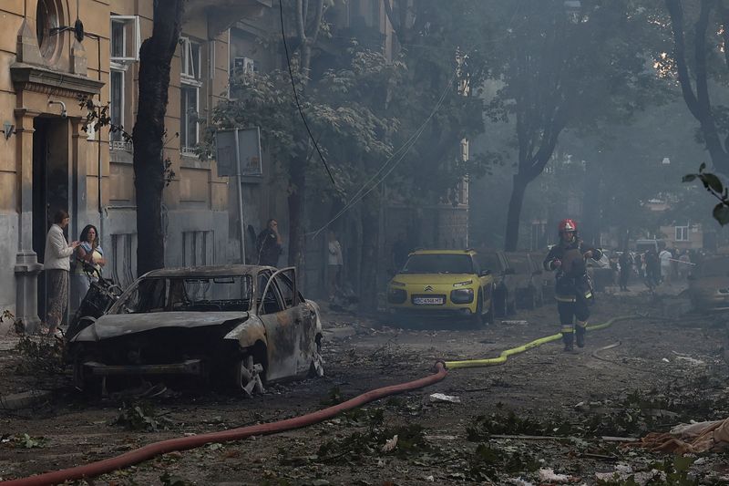 © Reuters. A rescuer walks along cars damaged during a Russian drone and missile strike, amid Russia's attack on Ukraine, in Lviv, Ukraine September 4, 2024. REUTERS/Roman Baluk