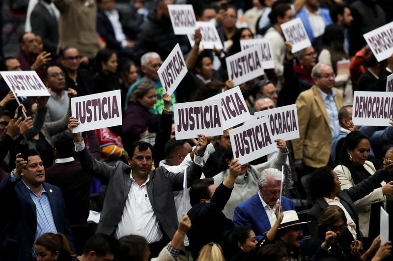 © Reuters. Lawmakers raise posters reading 