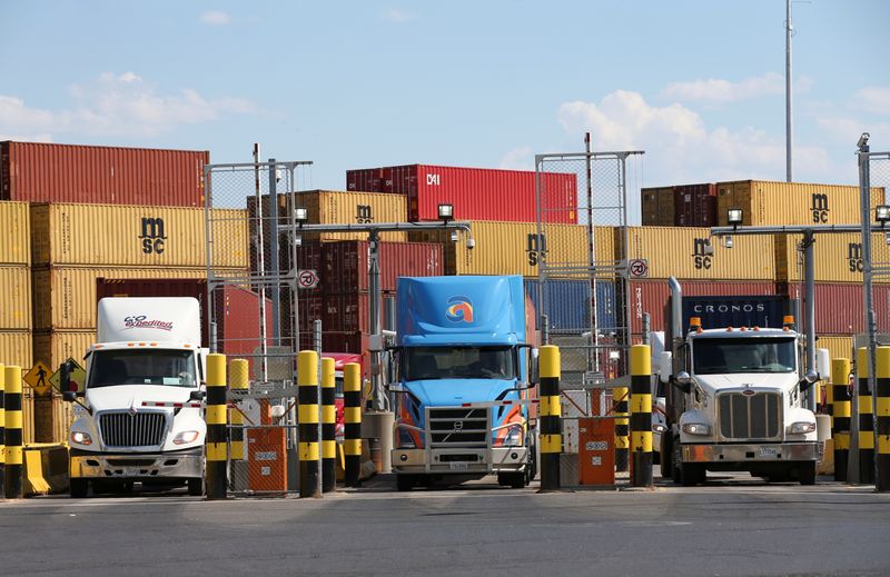 © Reuters. FILE PHOTO: Trucks loaded with shipping containers leave the Port of Montreal in Montreal, Quebec, Canada, May 17, 2021.  REUTERS/Christinne Muschi/File Photo