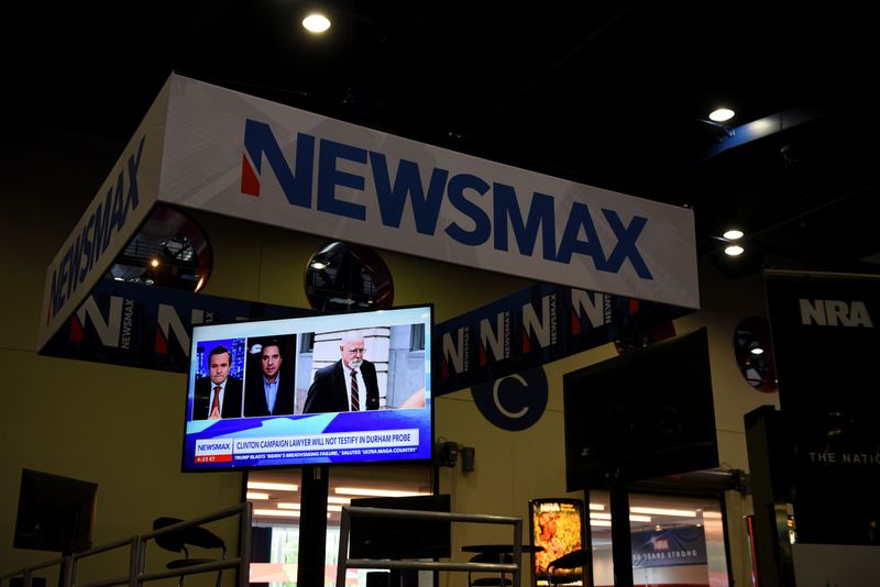 © Reuters. FILE PHOTO: A Newsmax booth broadcasts at the National Rifle Association (NRA) annual convention in Houston, Texas, U.S. May 29, 2022. REUTERS/Callaghan O'Hare/ File Photo