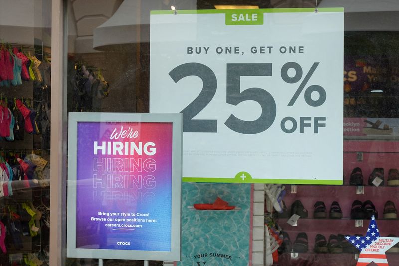 © Reuters. FILE PHOTO: A hiring sign and a for sale sign are displayed at a retail store in Carlsbad, California, U.S., May 25, 2023. REUTERS/Mike Blake/File Photo