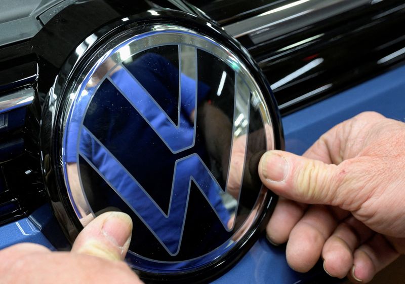 &copy; Reuters. FILE PHOTO: Volkswagen logo is fixed by an employee on a production line for the Golf VIII and Tiguan cars at the VW headquarters in Wolfsburg, Germany May 23, 2024. REUTERS/Fabian Bimmer/File Photo