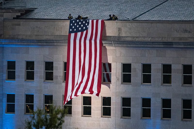 &copy; Reuters. FILE PHOTO: An American flag is unfurled from the roof of the Pentagon in Arlington, Virginia, U.S., September 11, 2021. REUTERS/Al Drago/File Photo